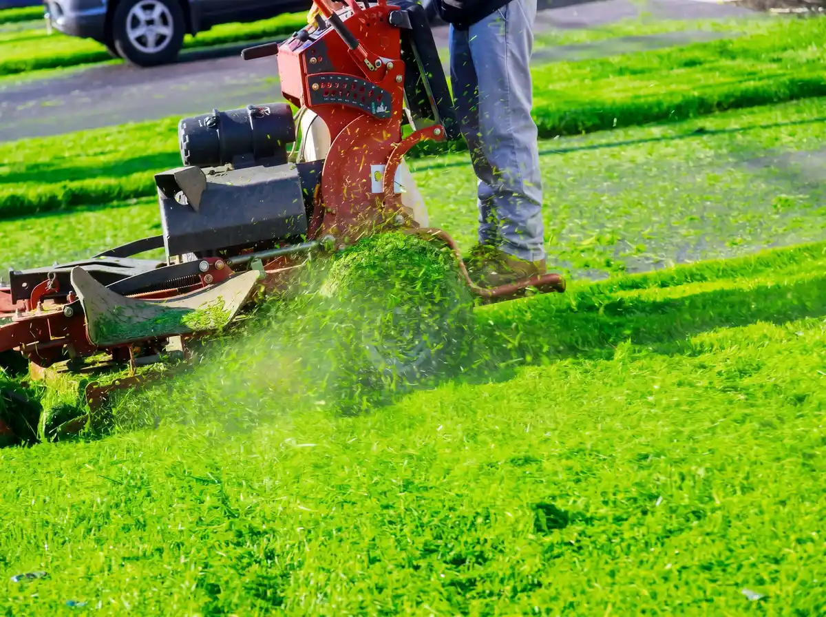 Lawn mower cutting grass in Huntsville AL from King's Cut Landscaping